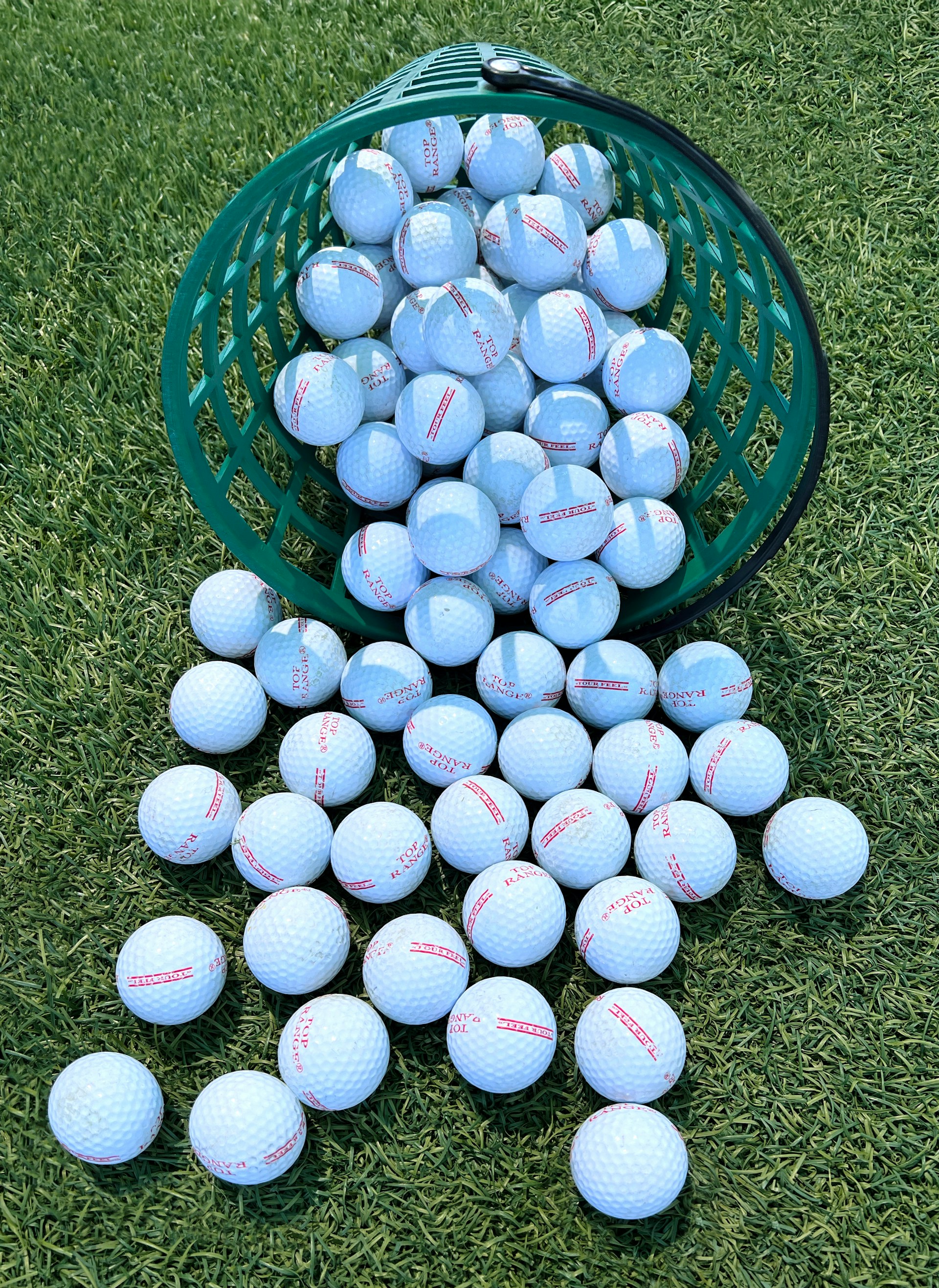 Basket of range balls on the driving range grass
